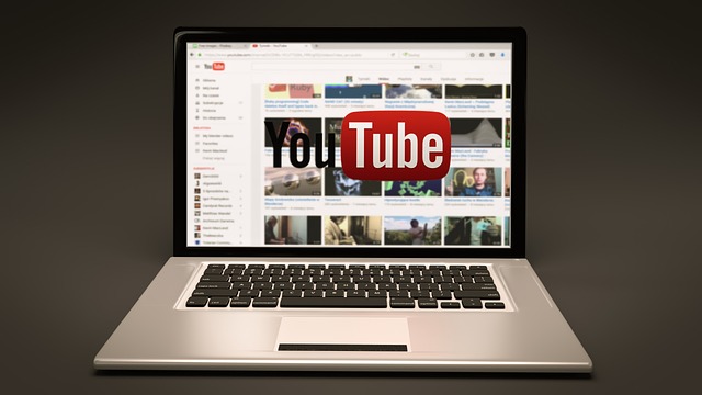 laptop with the YouTube homepage displayed on the screen