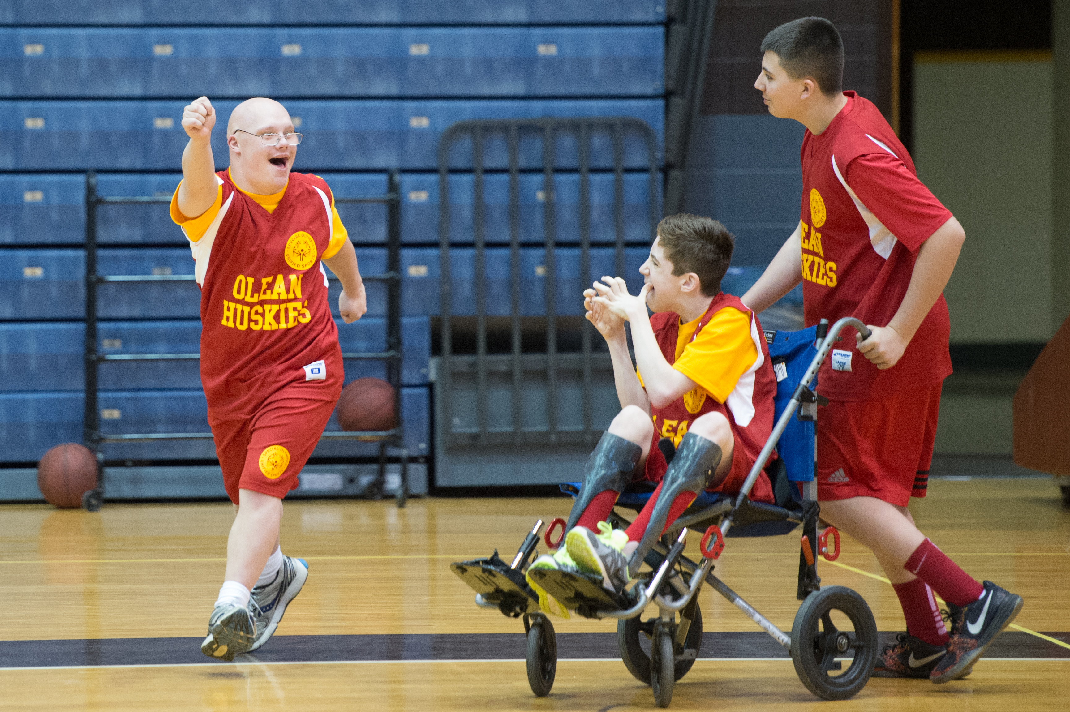 athletes with disabilities cheering on a basketball court