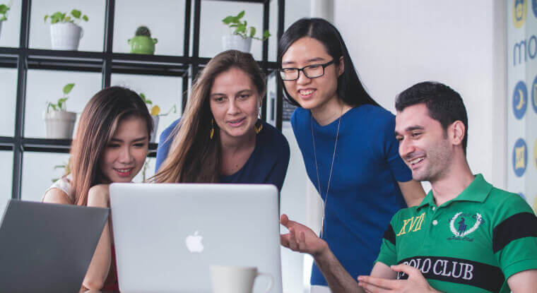 A group of people looking at the computer