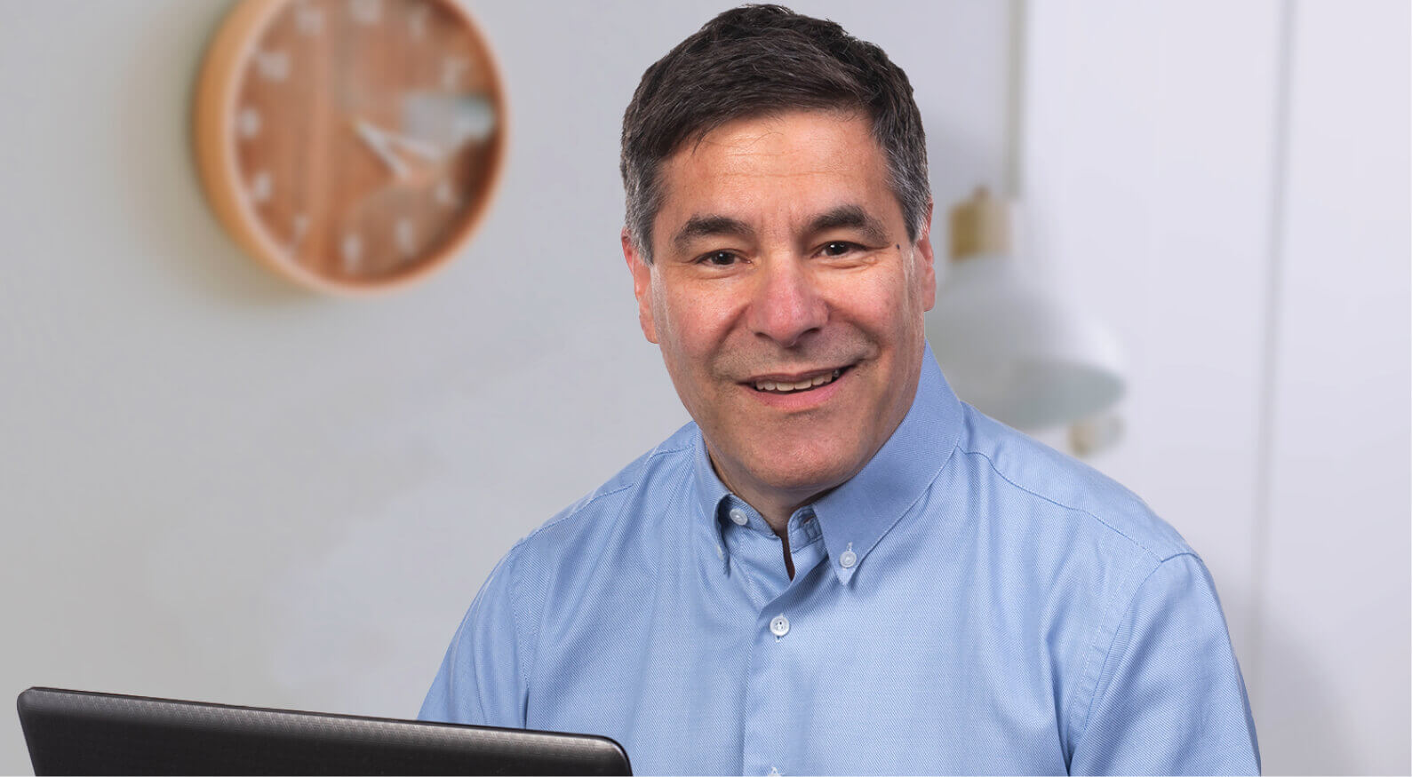 Sheldon Lewis from accessiBe smiling at the computer